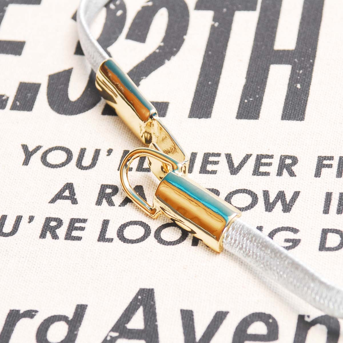 ムルーア ゴールドバックル細ゴムべルト シルバー 銀